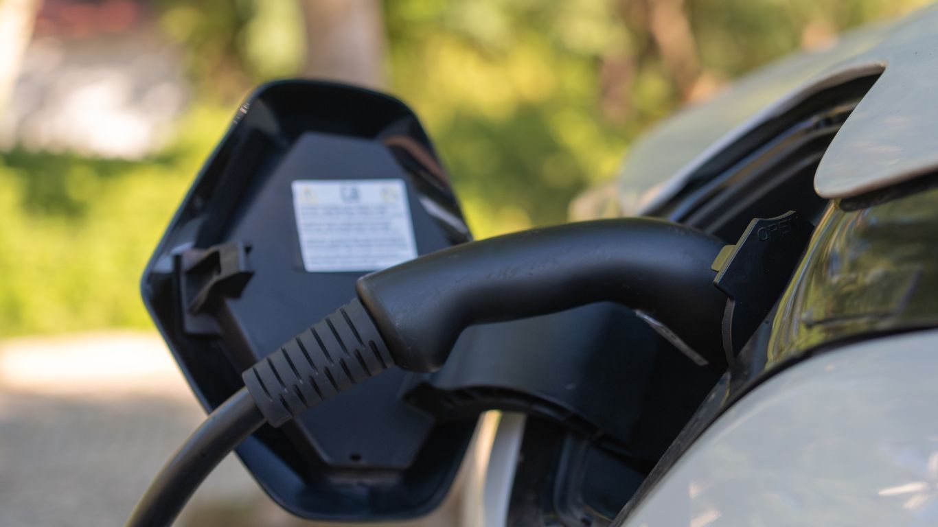 EV Car Charging Man Replacing Tesla Charger