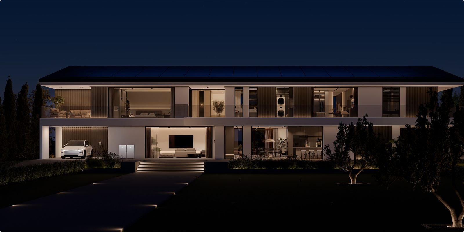 Tesla-powered home at night with solar roof, Powerwall, and a Model Y charging in the carport